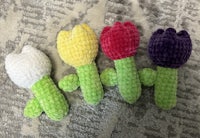 four stuffed tulips on a blanket